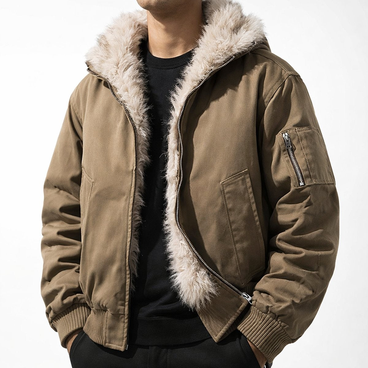 Man wearing khaki bomber jacket with faux fur-lined hood and sleeve zip pocket