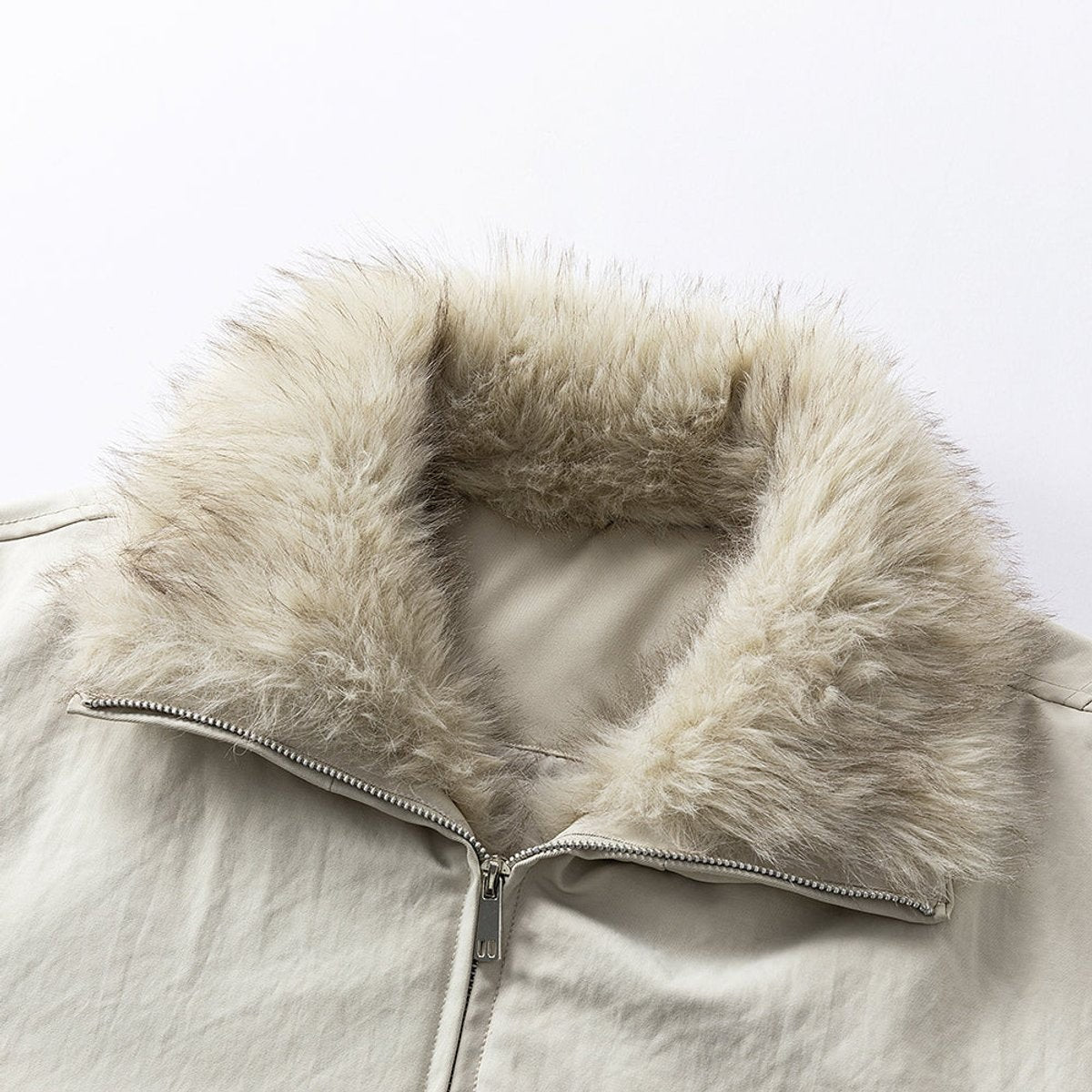 Close-up of beige faux fur-lined hood on cream bomber jacket