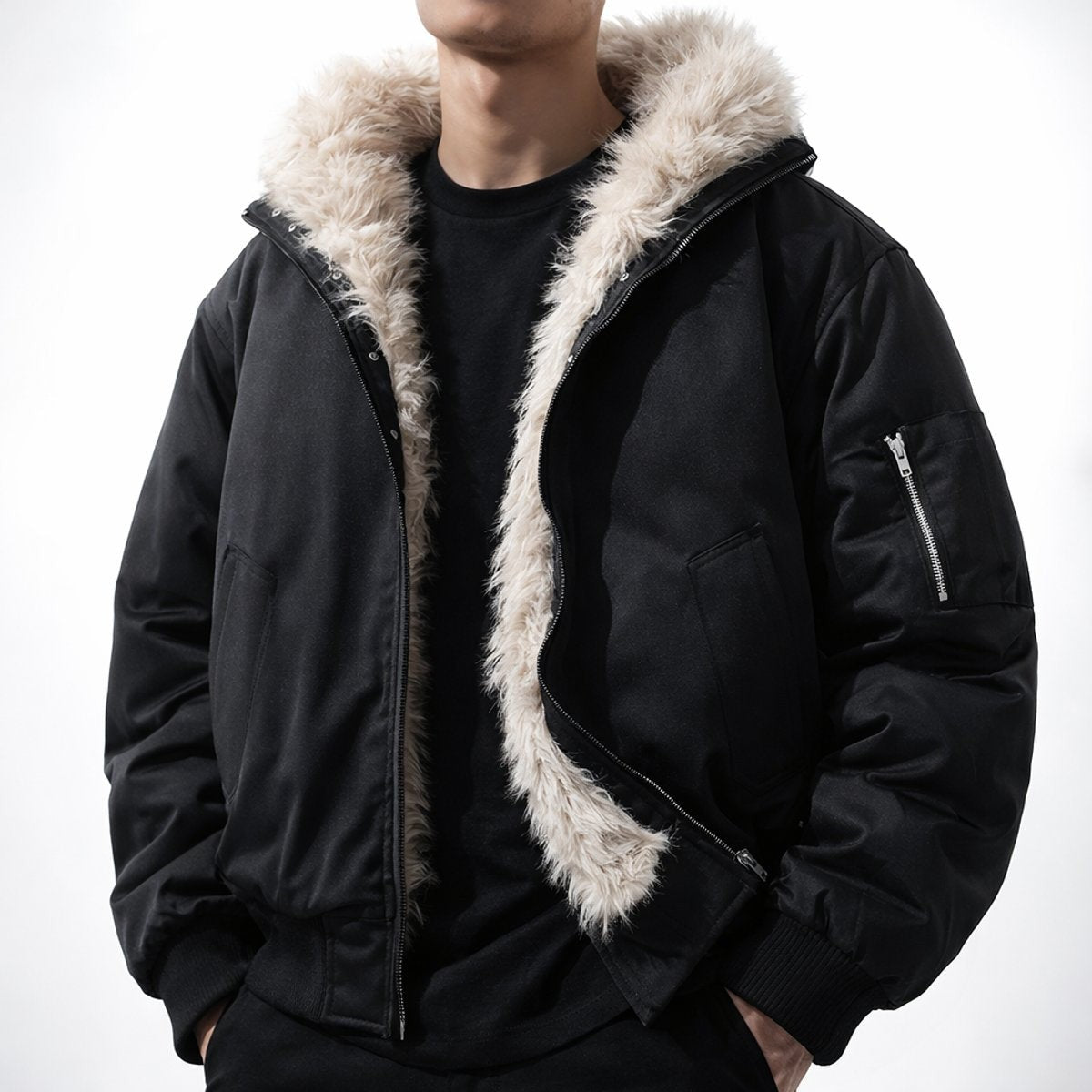 Man wearing black faux fur-lined bomber jacket with sleeve zip pocket