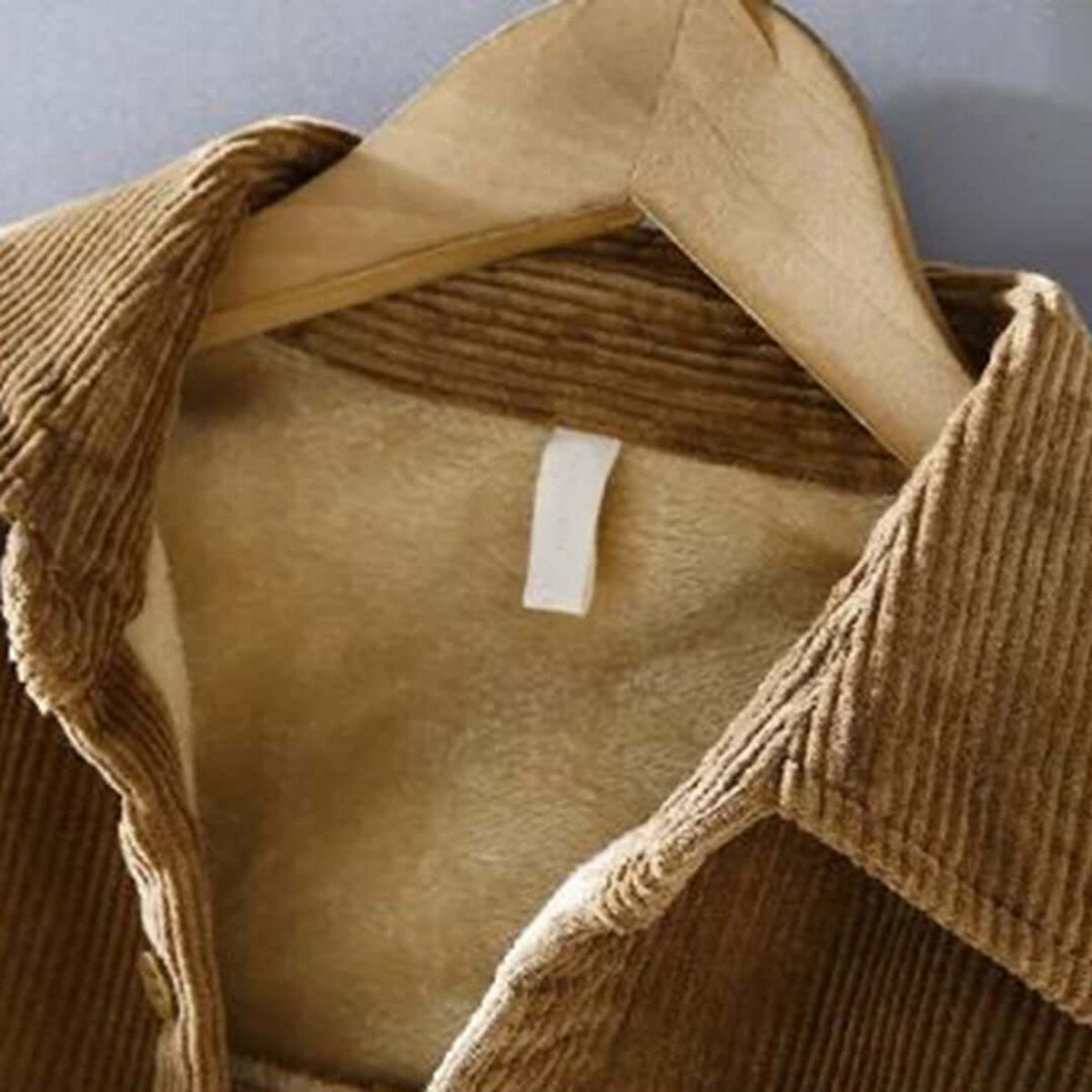 Close-up of fleece lining inside camel corduroy jacket collar
