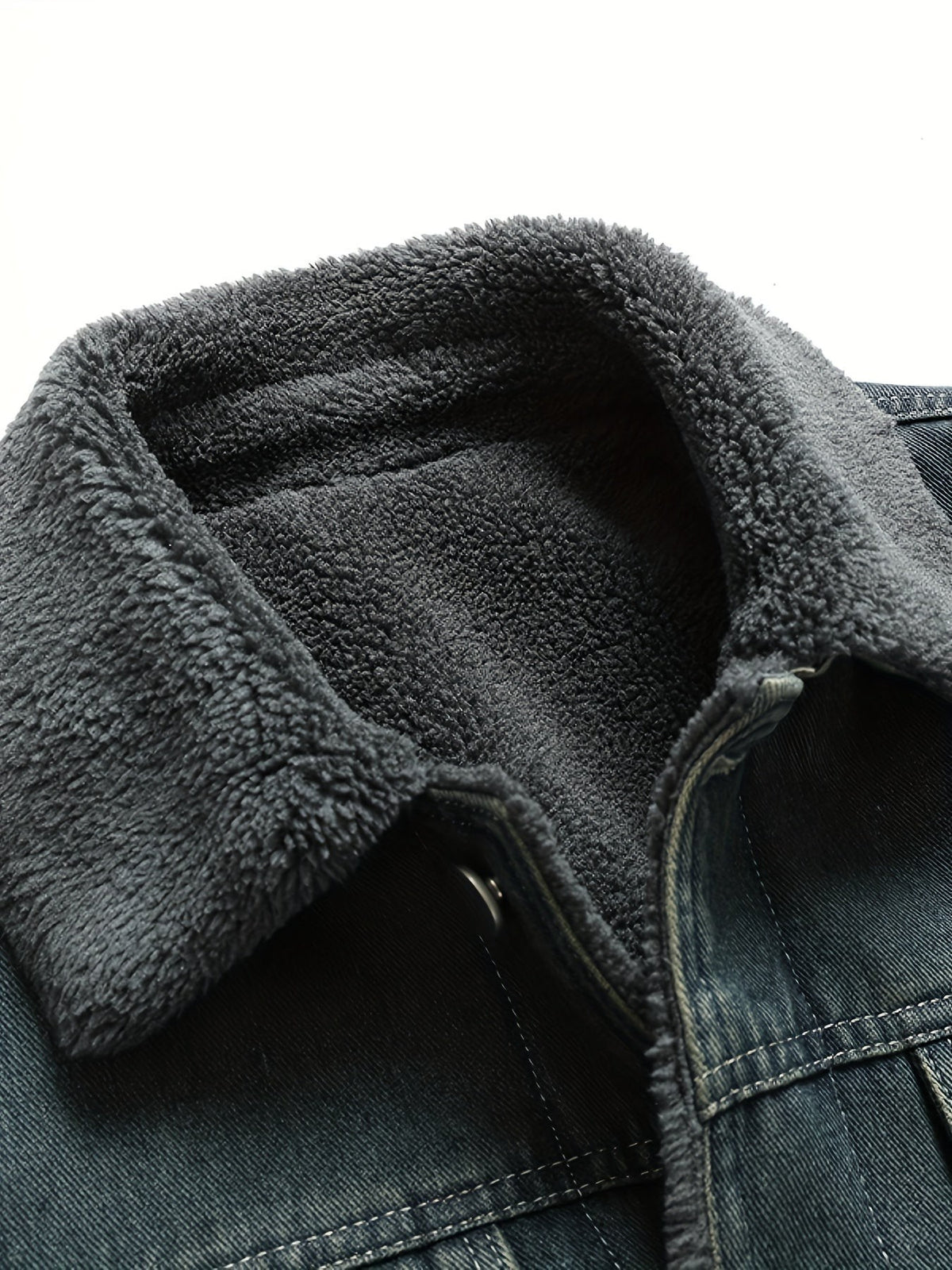 Detailed view of grey fleece collar lining against dark denim fabric