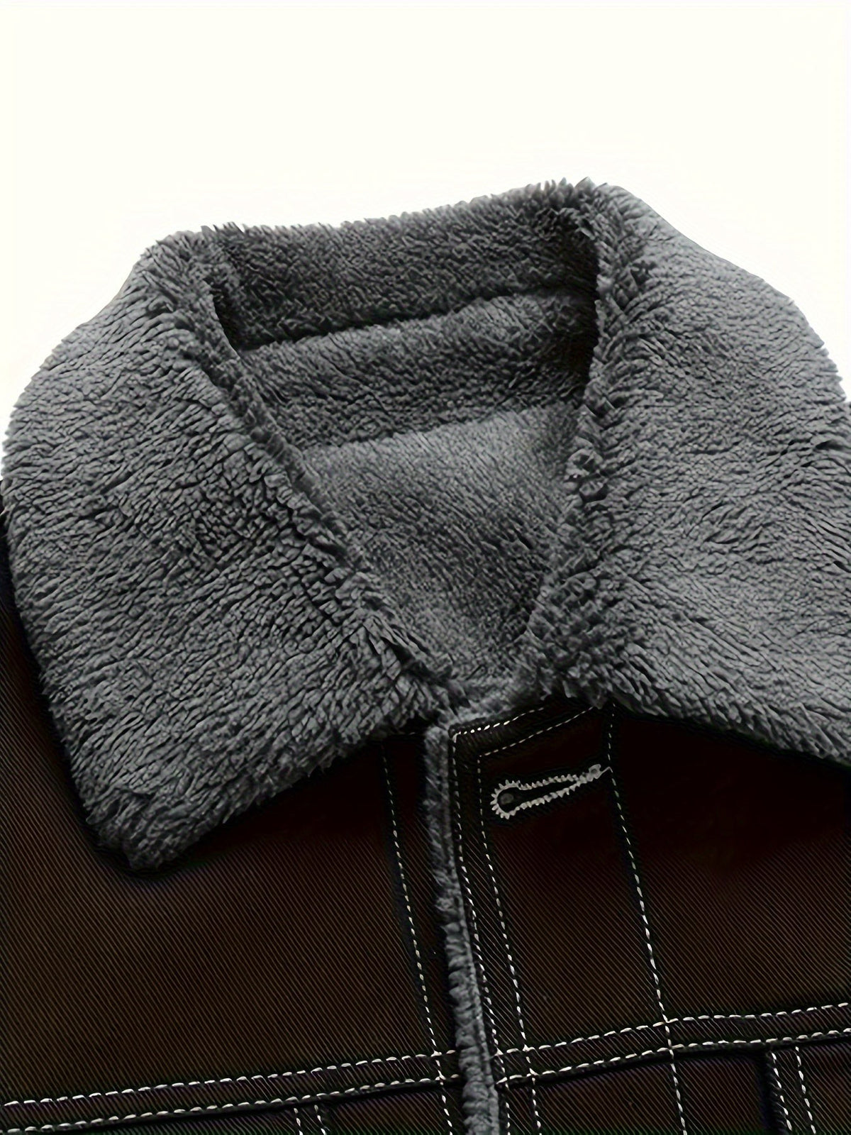 Close-up of grey sherpa fleece collar lining on denim jacket