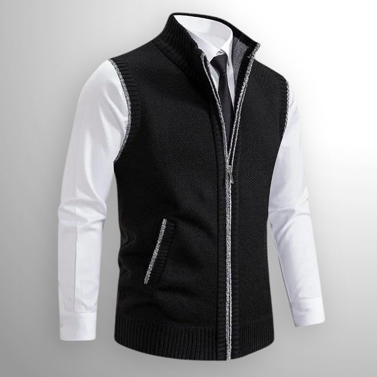 Black knitted zip-up gilet with contrast trim, styled over a white shirt