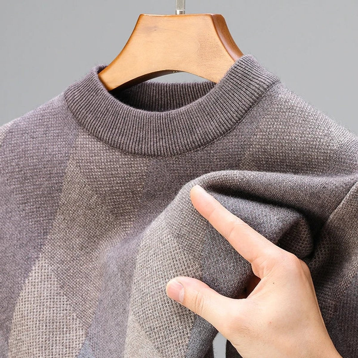 Close-up of grey argyle jumper showing soft knitted texture