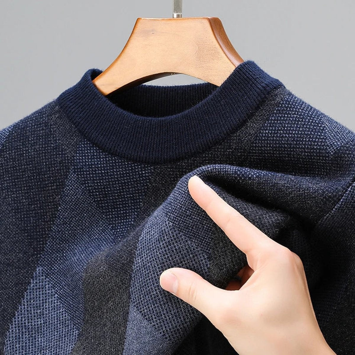 Close-up of navy knit jumper collar with chunky ribbed trim