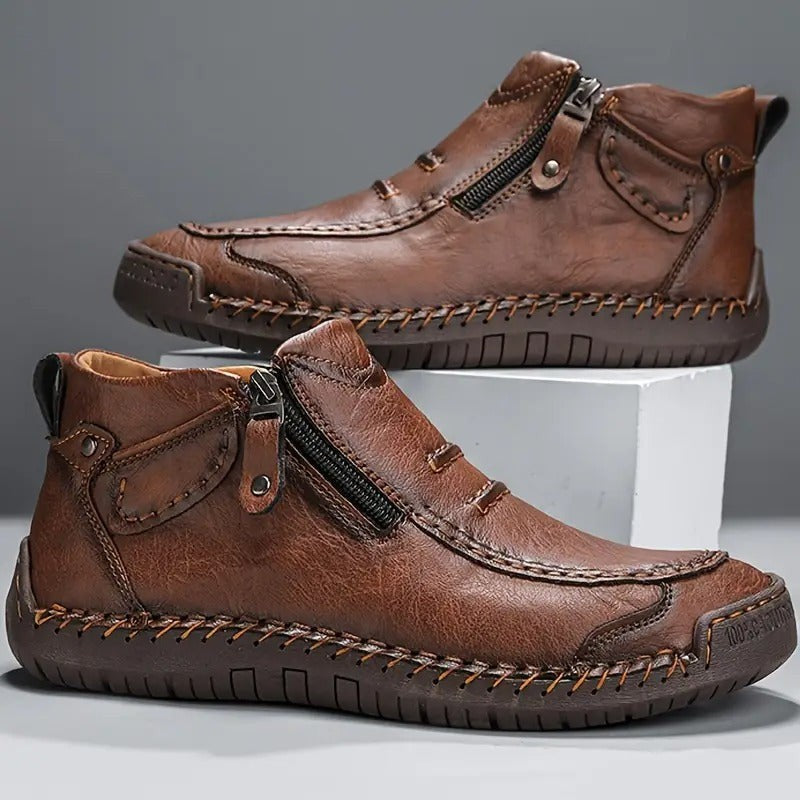 Pair of brown leather men's boots with zip fastening and stitched sole