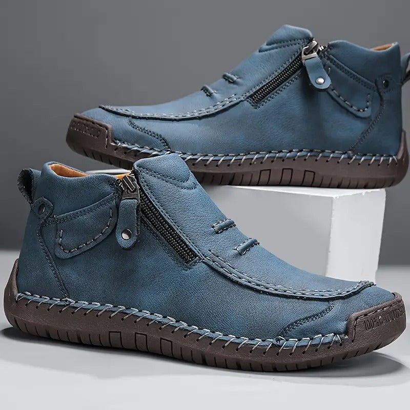 Blue leather ankle boots featuring side zip and hand-stitched trim