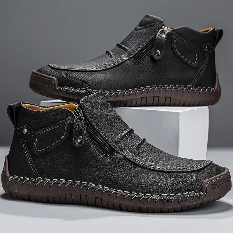 Black leather men's boots with contrast stitching and zip closure