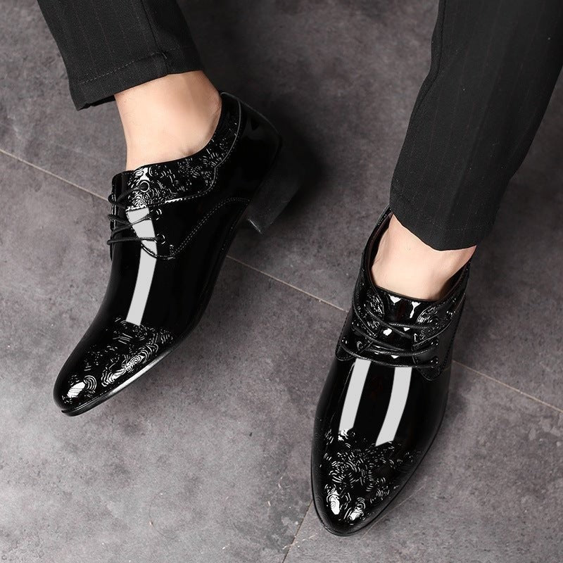 Men's black patent lace-up shoes worn with tailored trousers, glossy finish