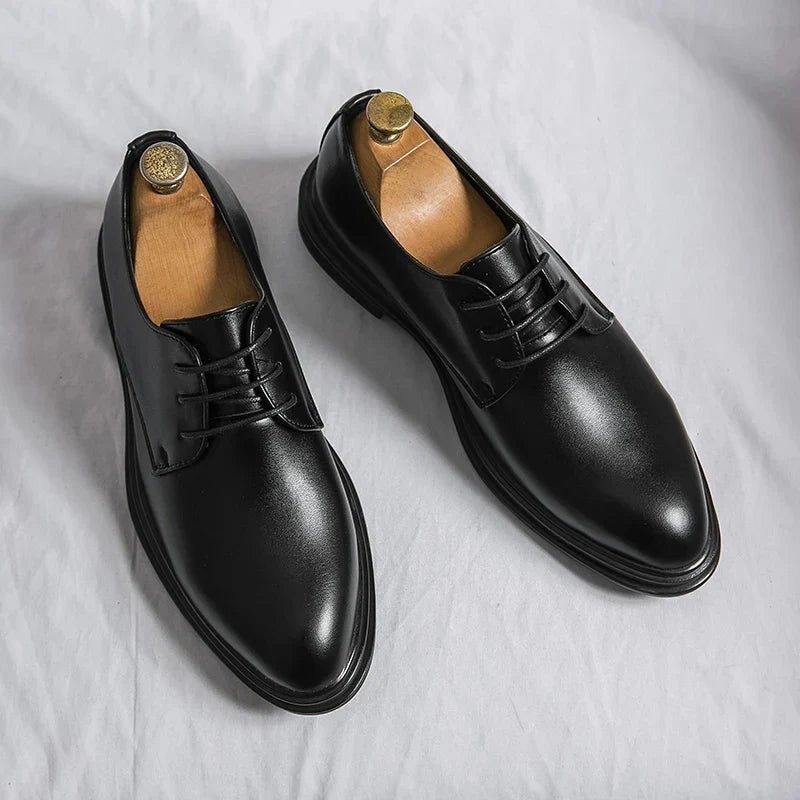 Pair of black leather lace-up Derby shoes with pointed toe design