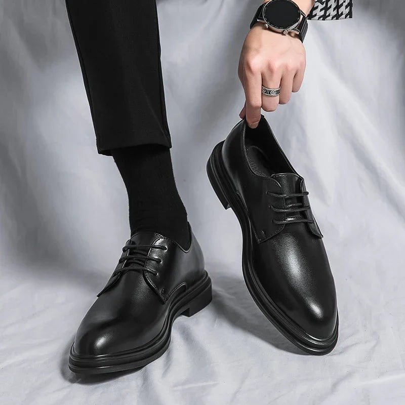 Man wearing black leather Derby shoes with tailored trousers and socks