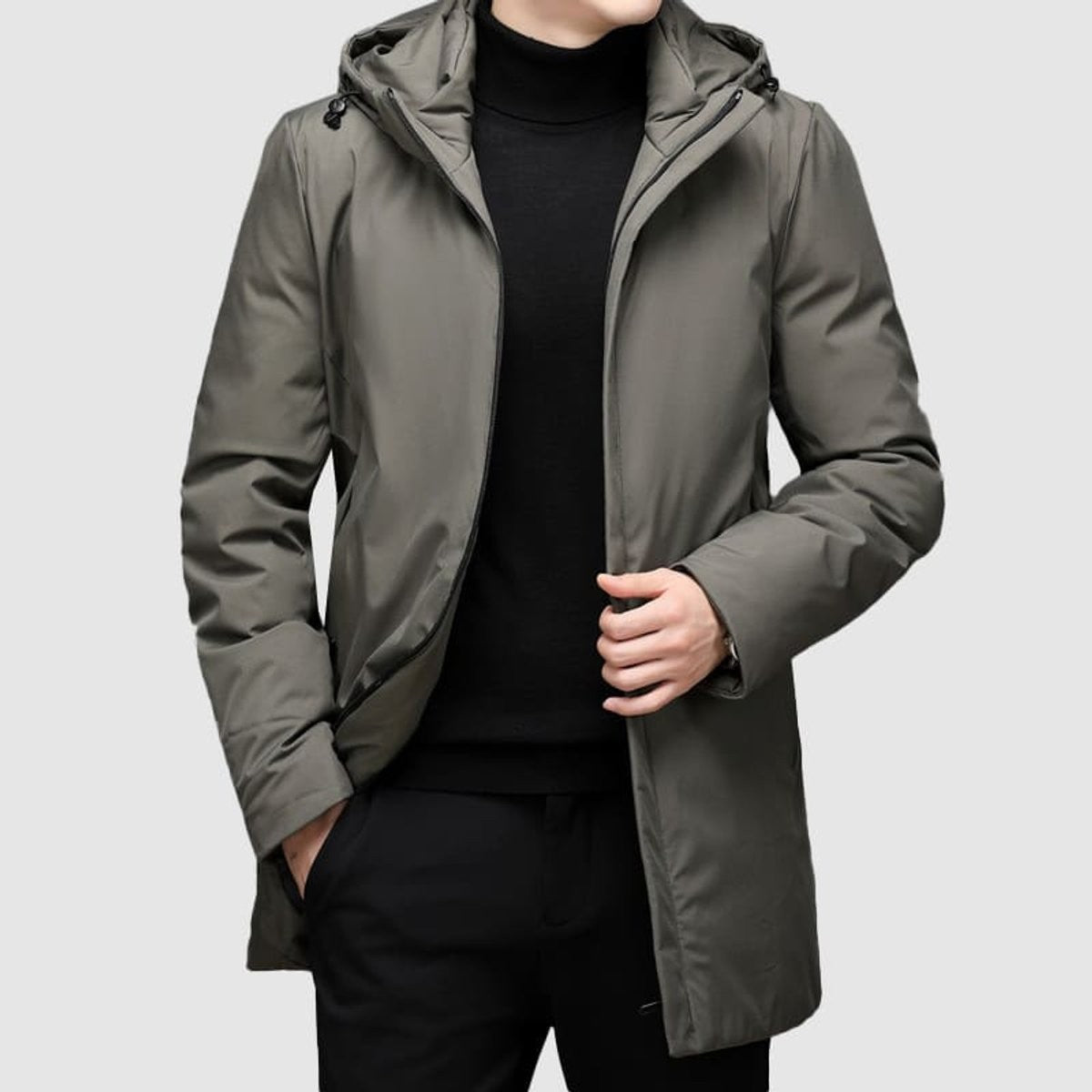 Khaki hooded parka worn open over a black roll-neck jumper