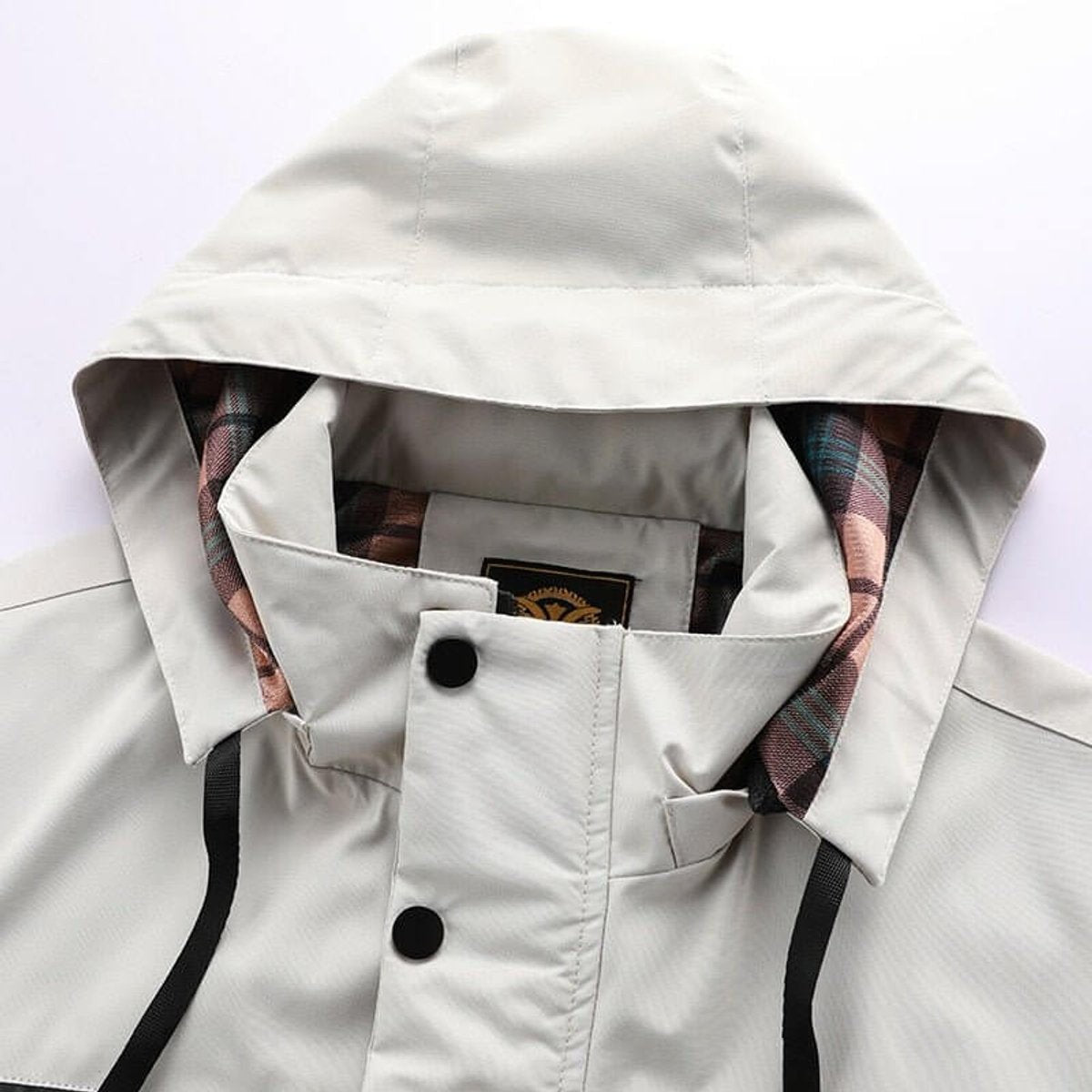 Close-up of hood and collar with tartan lining and popper fastenings