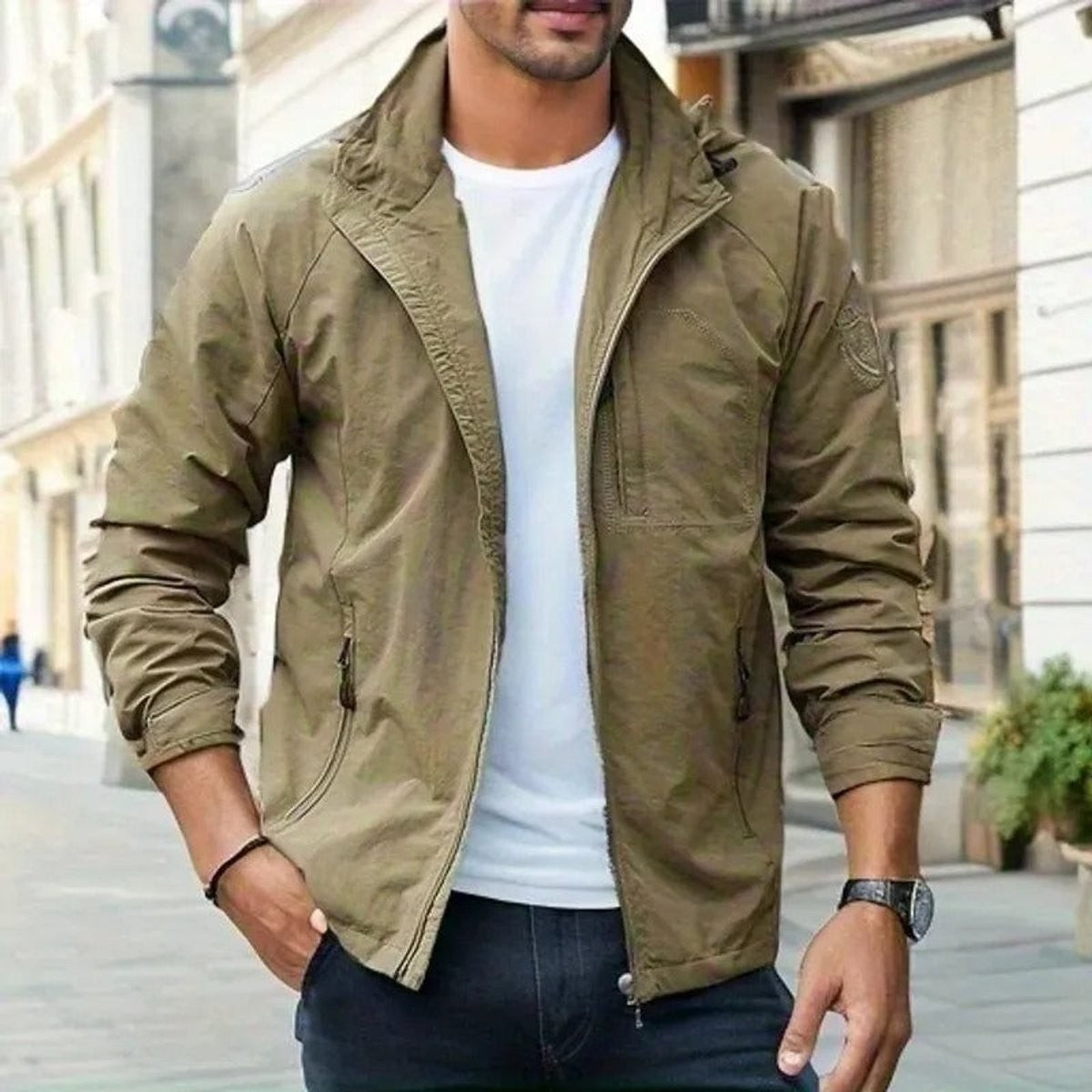 Man wearing khaki zip-up bomber jacket with stand collar and chest pocket