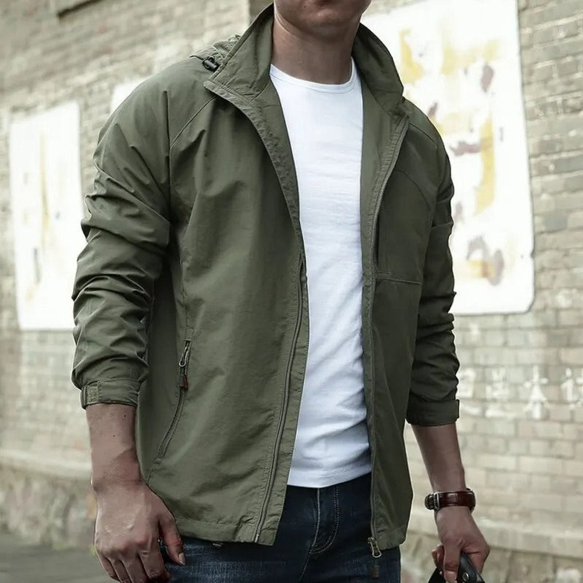 Man wearing olive green hooded zip-up jacket with chest pocket detailing