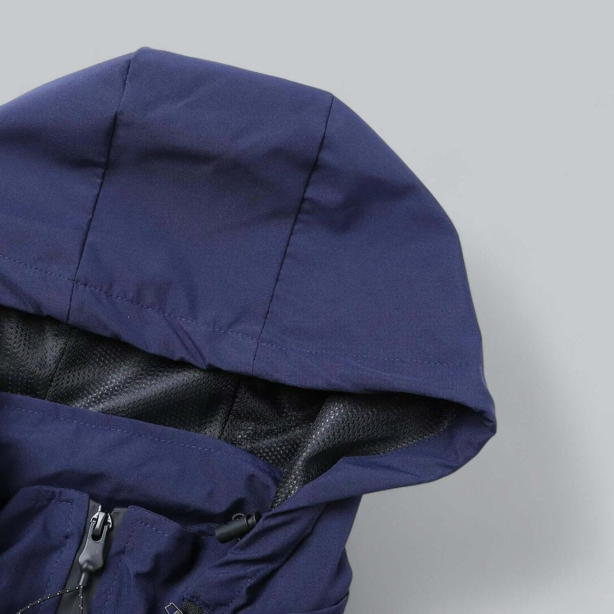 Close-up of navy jacket hood with mesh lining detail