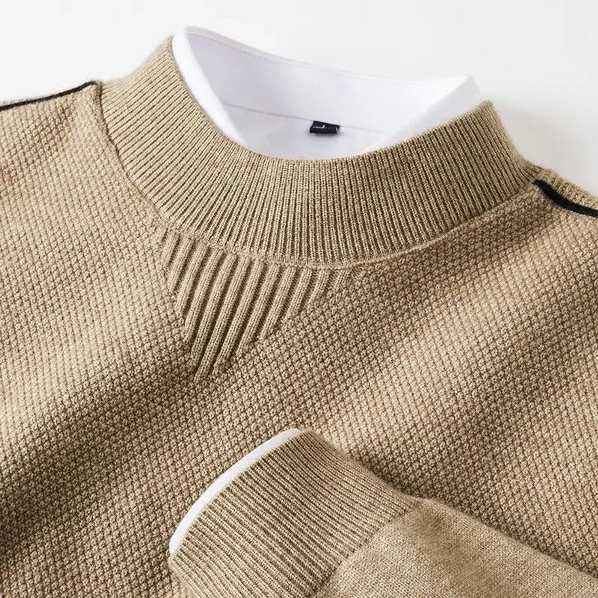 Beige mock-neck jumper with waffle-knit texture and layered white collar detail