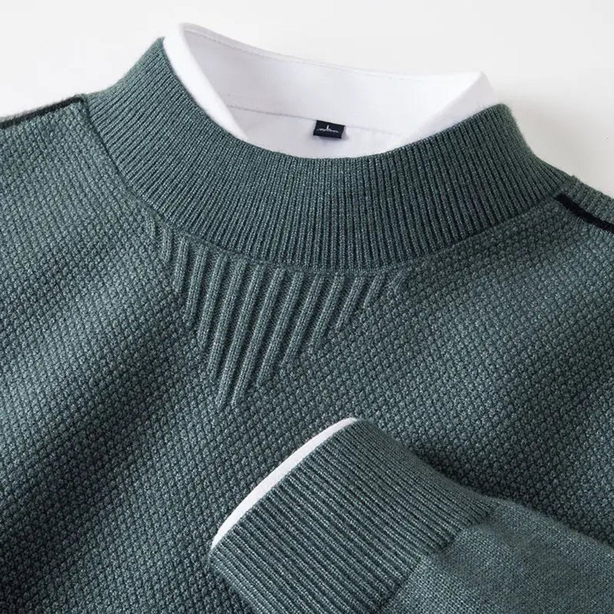 Sage green mock-neck jumper with textured knit and contrasting white collar