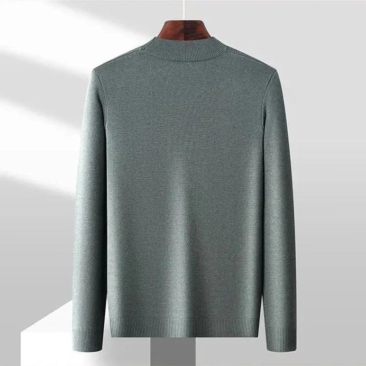 Grey-green ribbed pullover shown from behind, highlighting relaxed fit