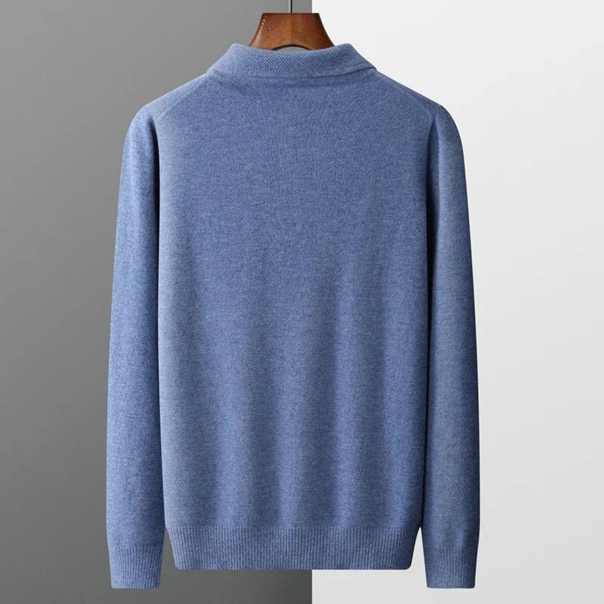 Back view of blue knitted polo jumper on a wooden hanger