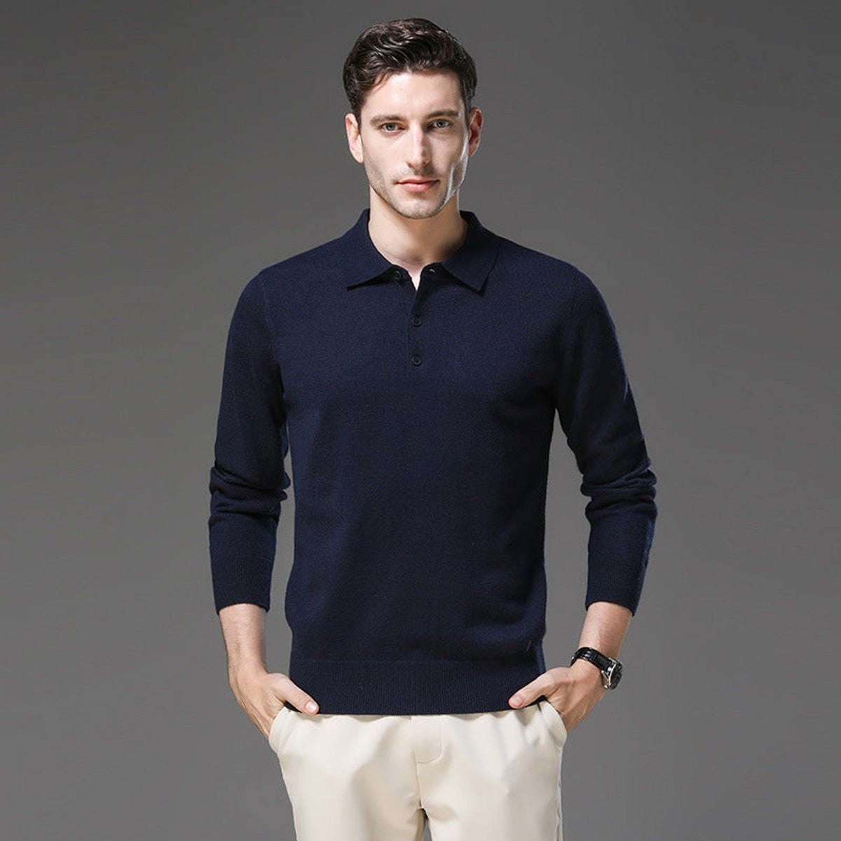 Man modelling navy knitted polo jumper with button-up collar