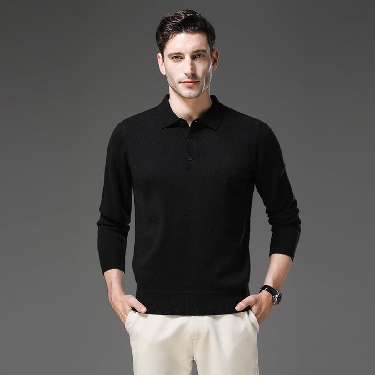 Man wearing black long-sleeve knitted polo jumper with ribbed cuffs