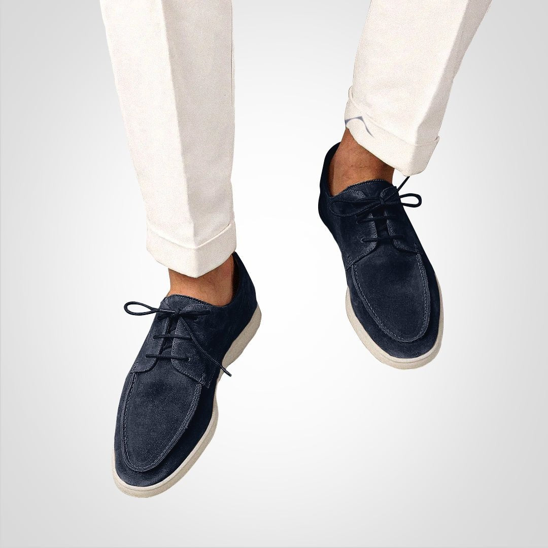Man wearing navy suede hybrid boat derby loafers with cream trousers