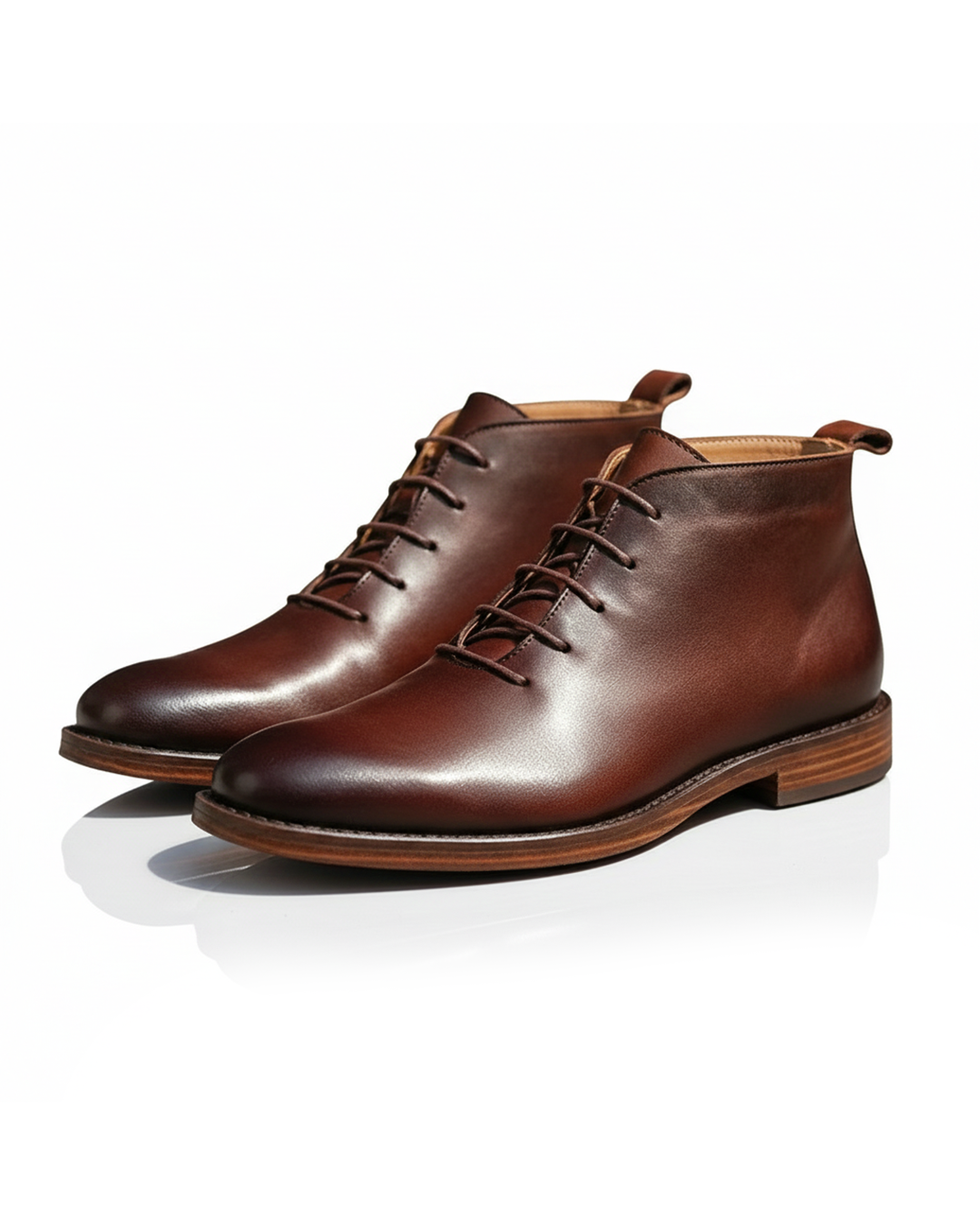 Pair of brown leather chukka boots with stitched wooden soles, angled view