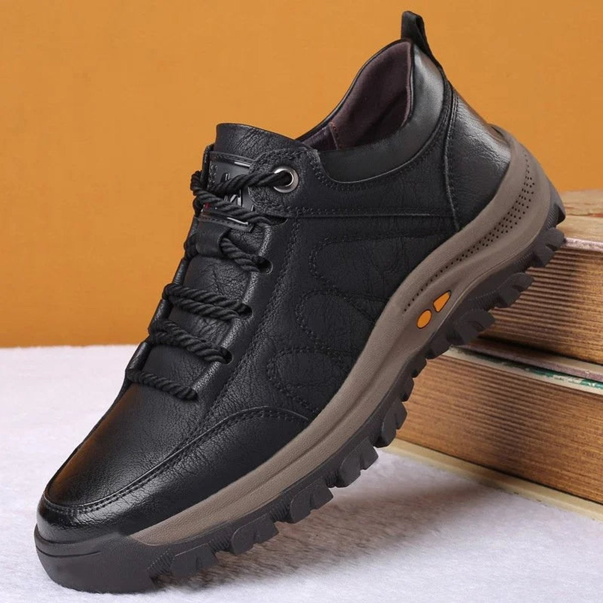 Side profile of black leather lace-up shoe with contrast brown sole