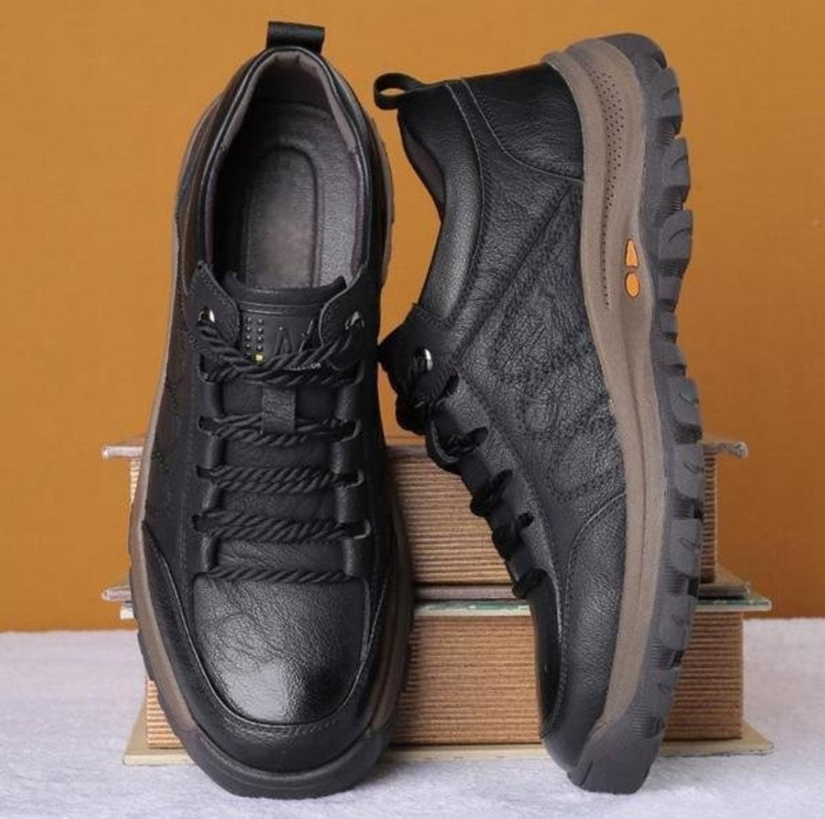 Overhead view of black leather lace-up shoes showing sole tread pattern