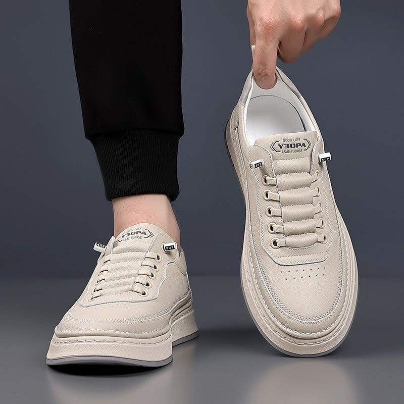 Cream leather trainer balanced on stool, close-up side view