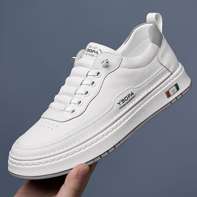 White leather trainer paired with matching shoe in background