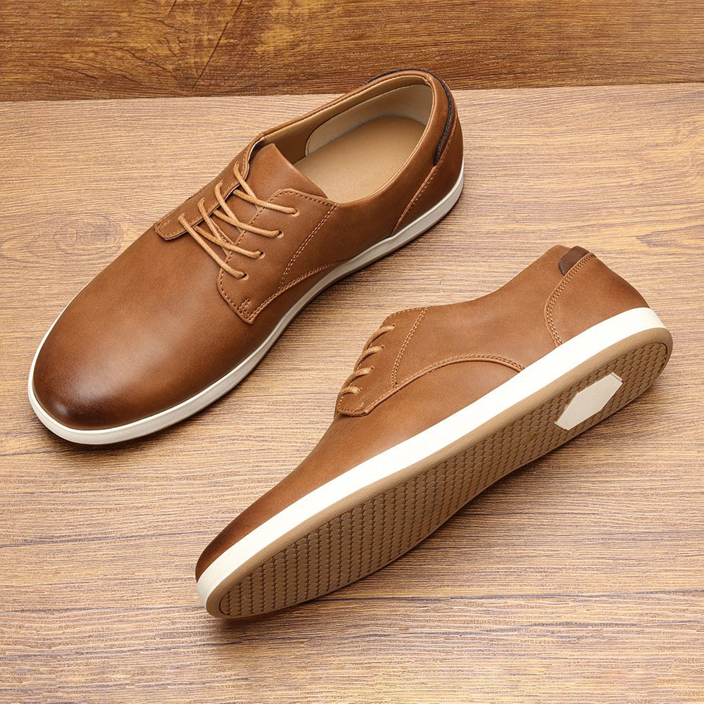Tan leather lace-up trainers with white sole shown as matching pair