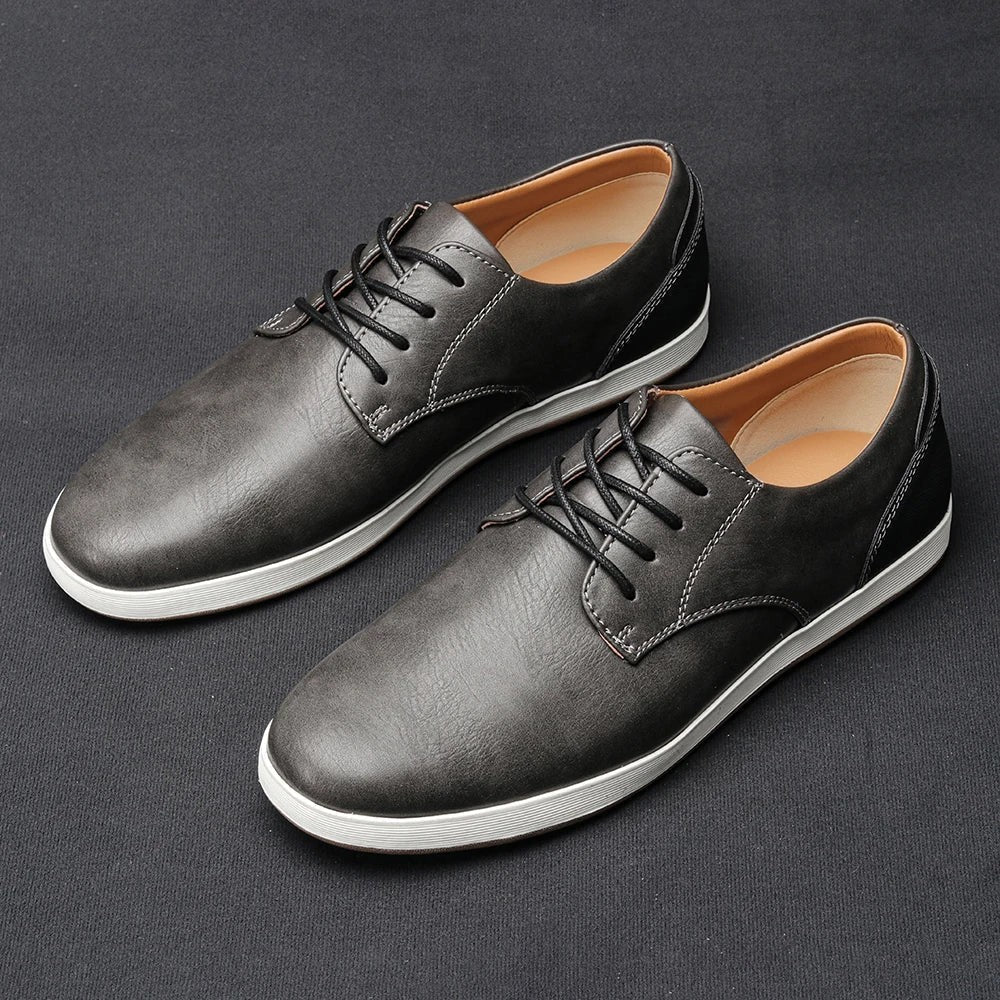 Grey leather lace-up trainers with black stitching and white sole detail
