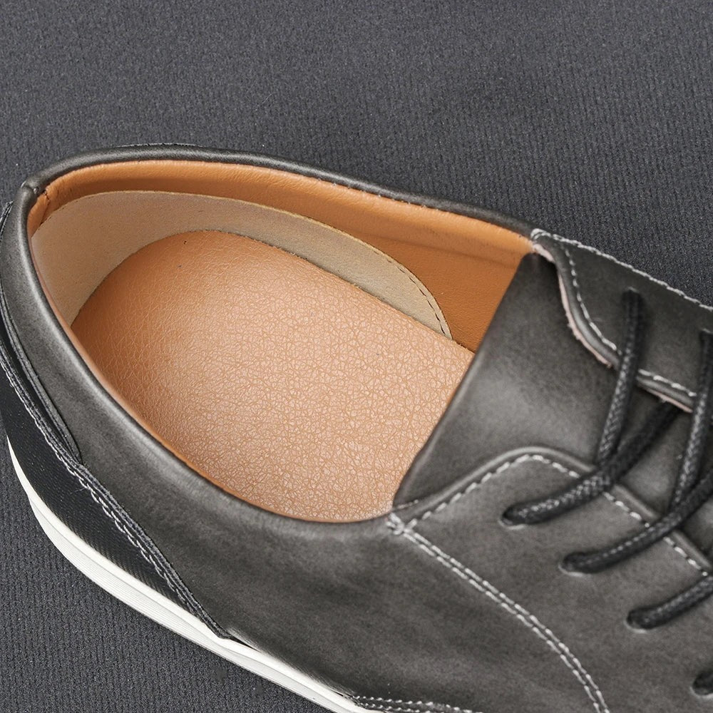 Close-up of tan leather insole and heel lining inside grey lace-up trainer