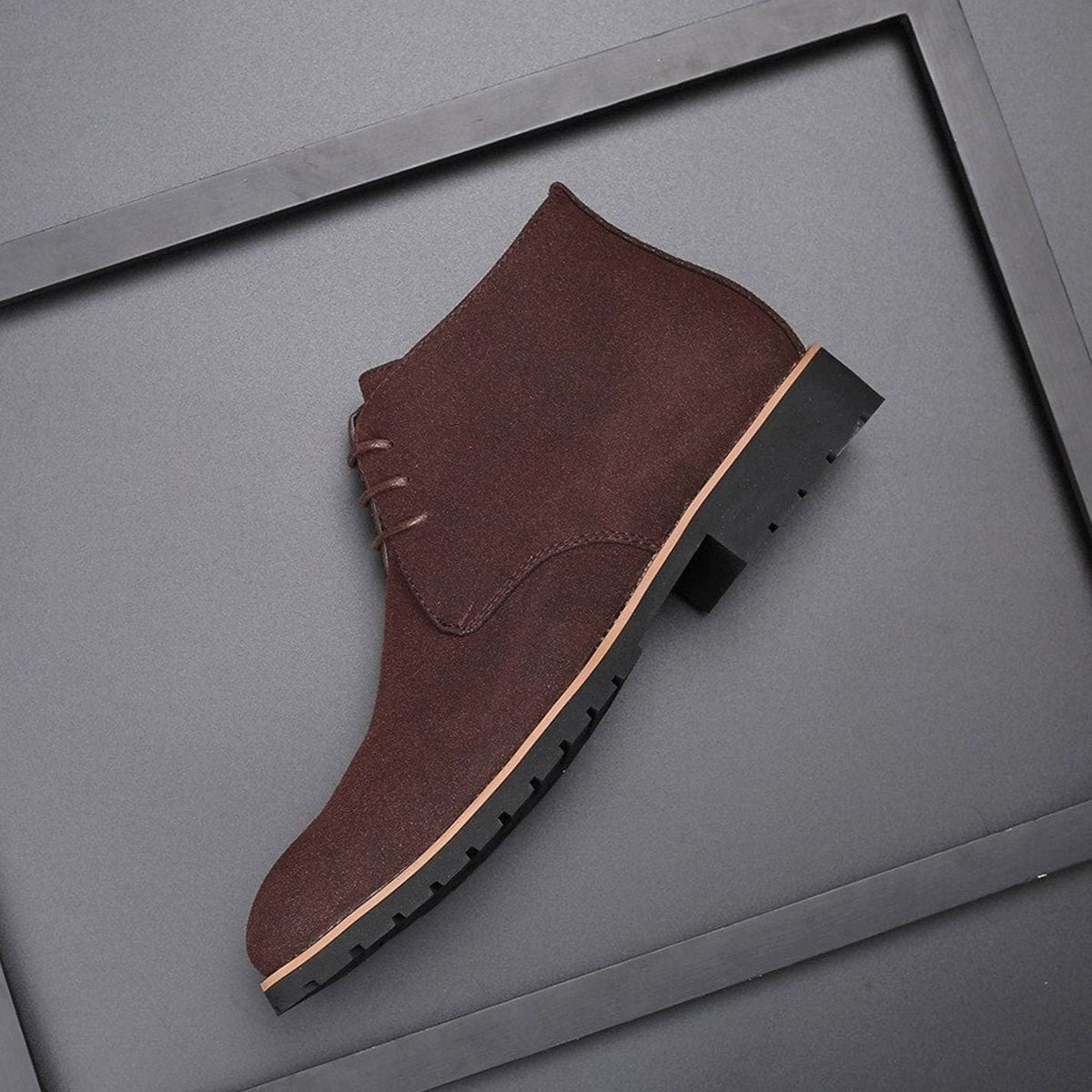 Brown suede lace-up ankle boot showing tan welt detail and stacked heel