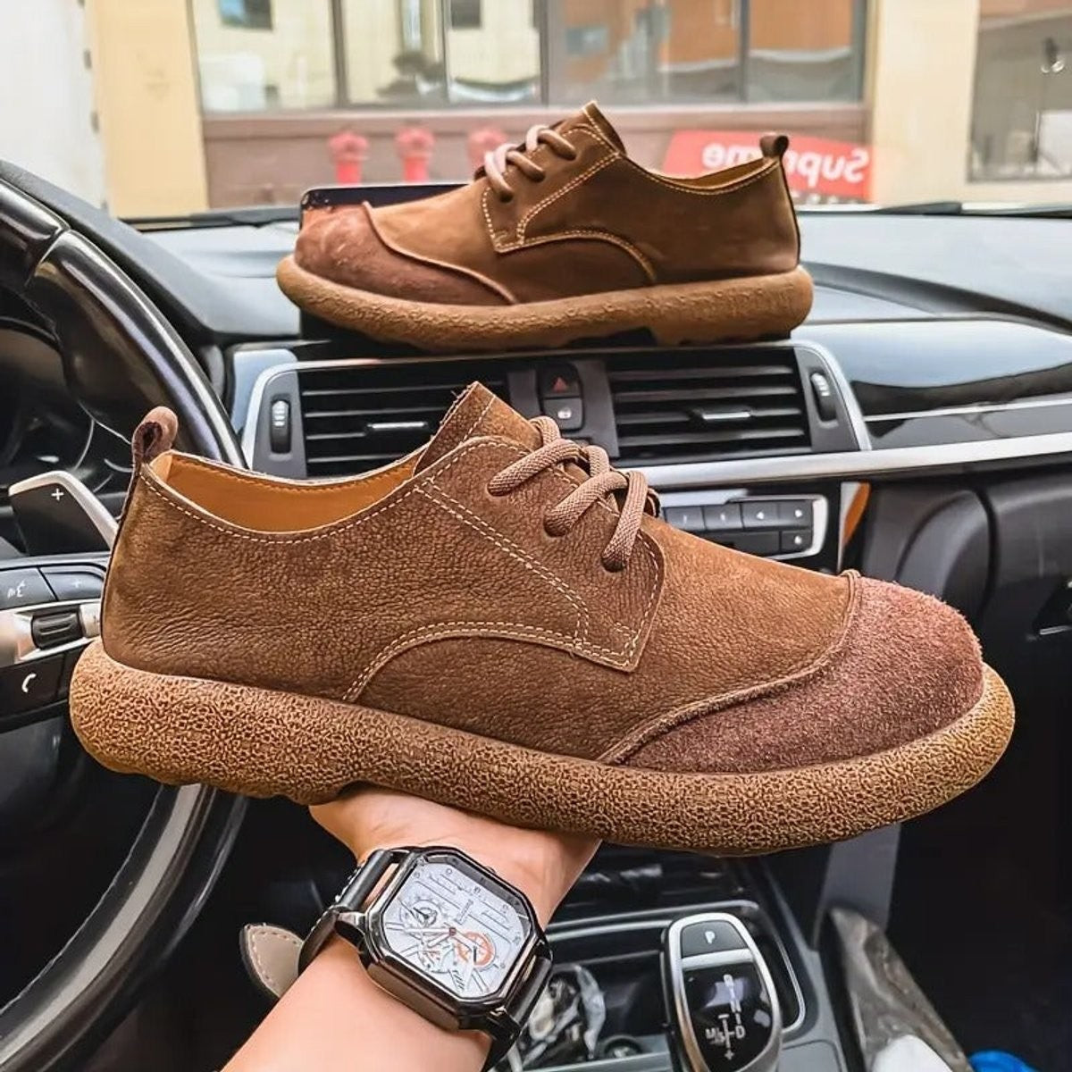 Camel leather lace-up shoes displayed beside chequered fabric