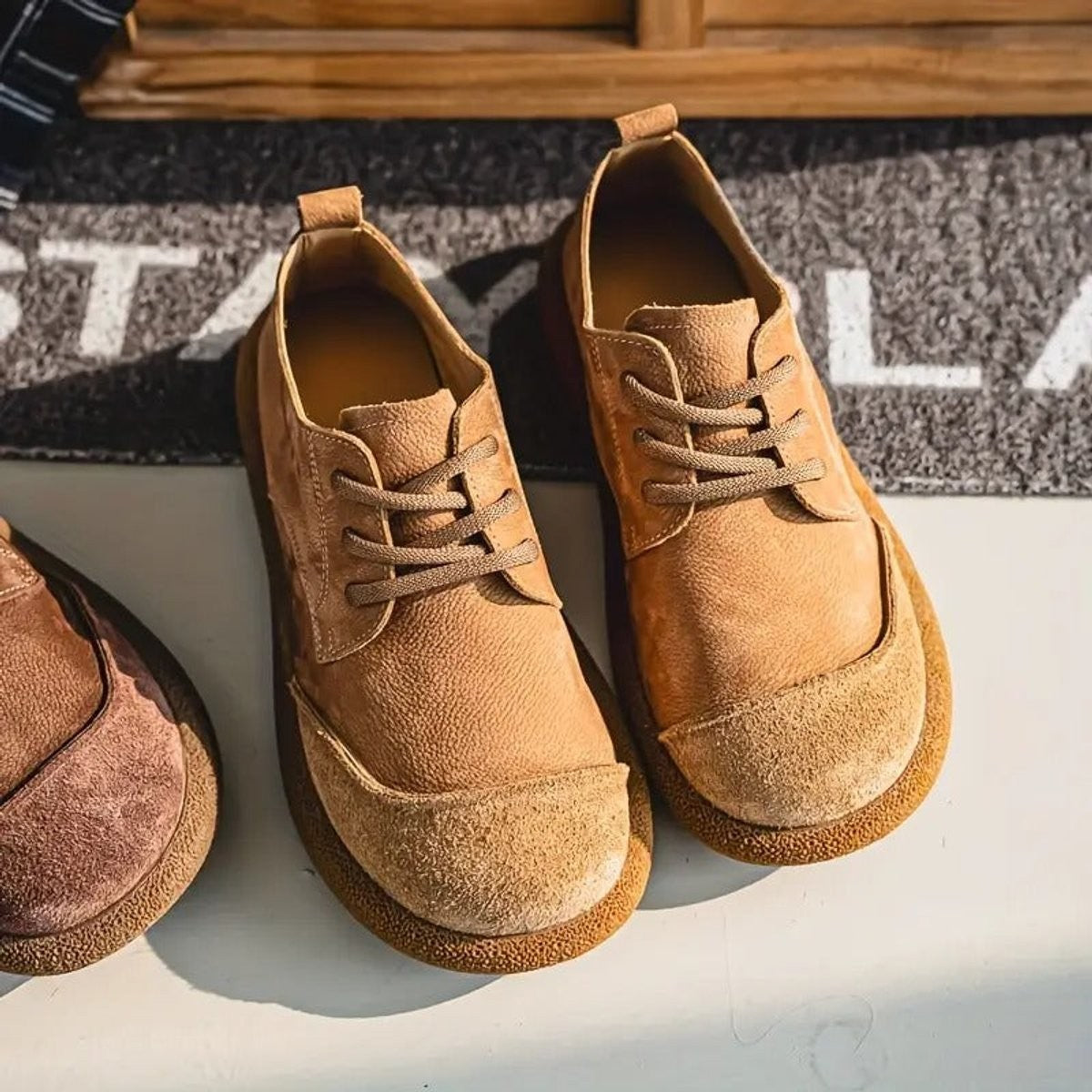 Camel leather trainers featuring contrast suede toe and lace fastening