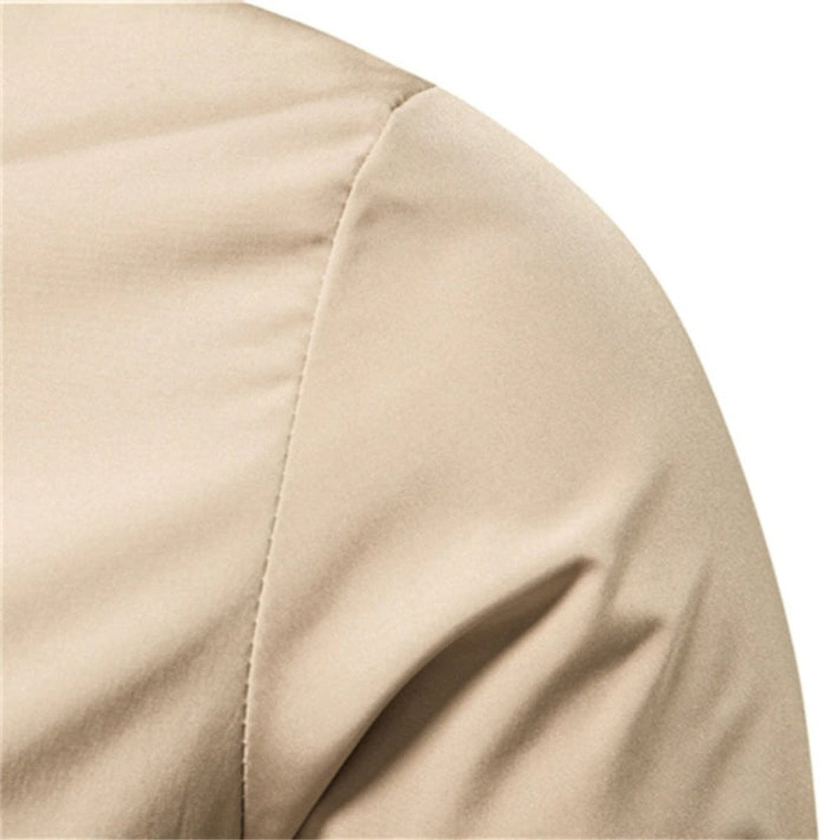Close-up of beige bomber jacket shoulder seam and fabric texture