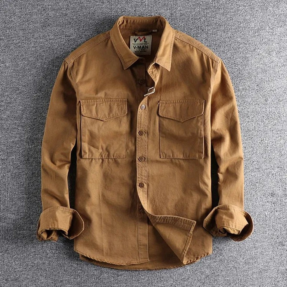 Tan long-sleeve utility shirt featuring twin flap pockets and buttoned cuffs