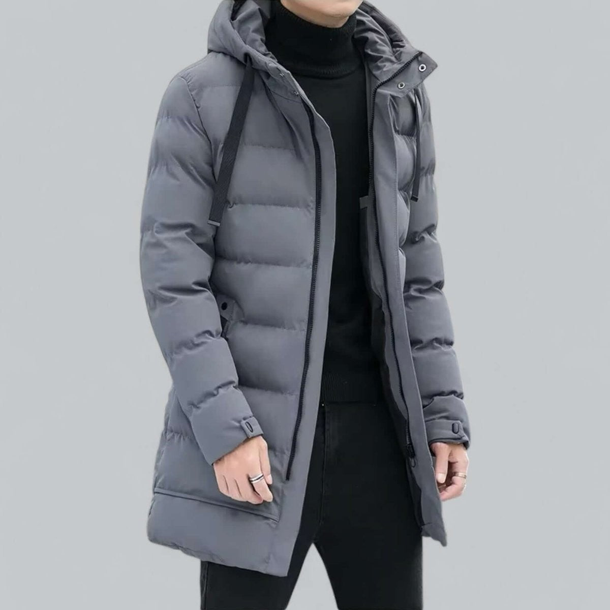 Grey quilted parka coat worn open over black jumper