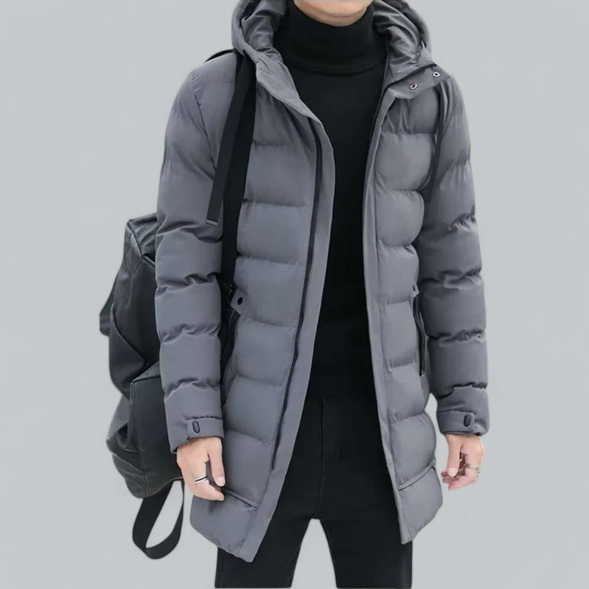 Grey padded parka with zip pocket, styled with black trousers