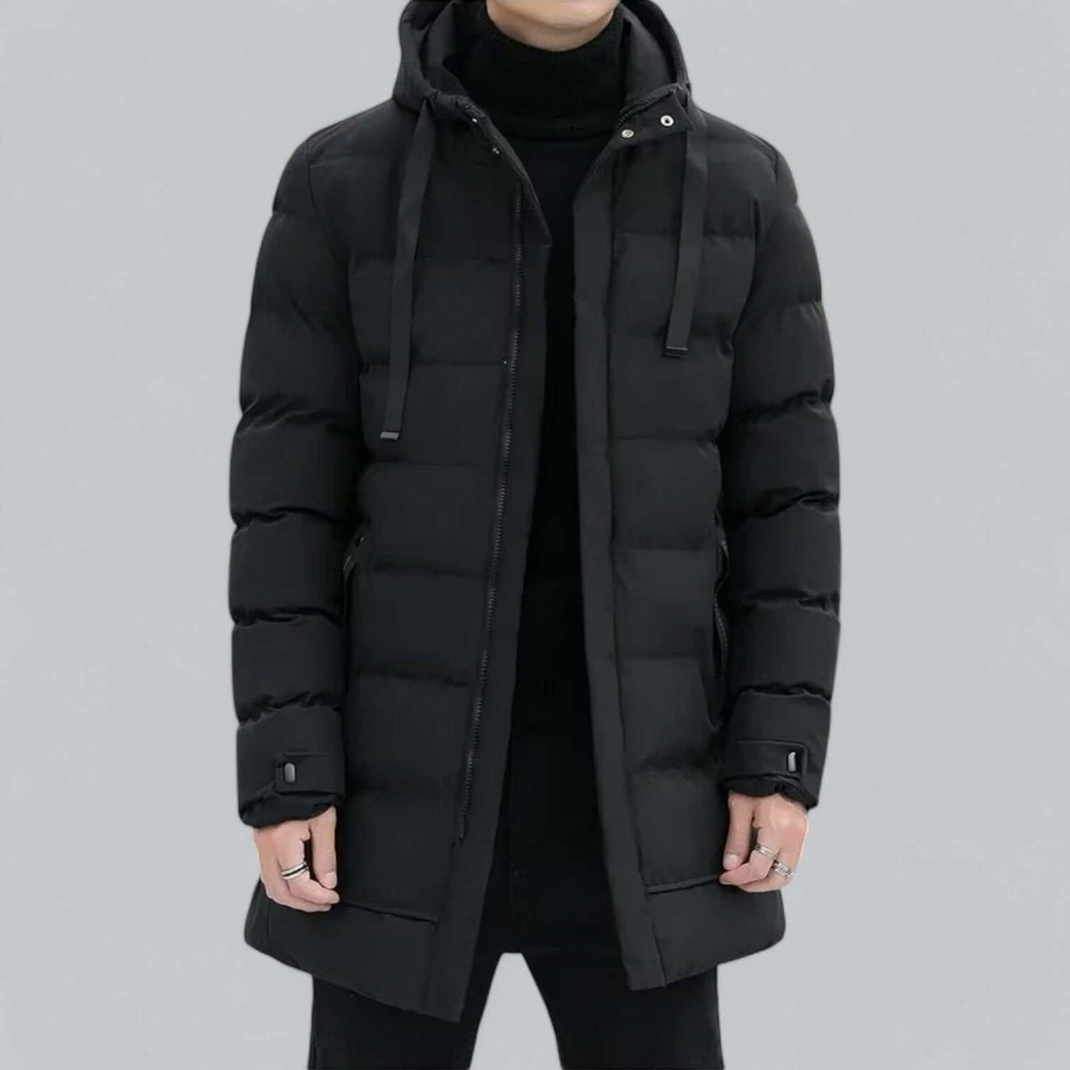 Grey longline hooded parka worn with black backpack