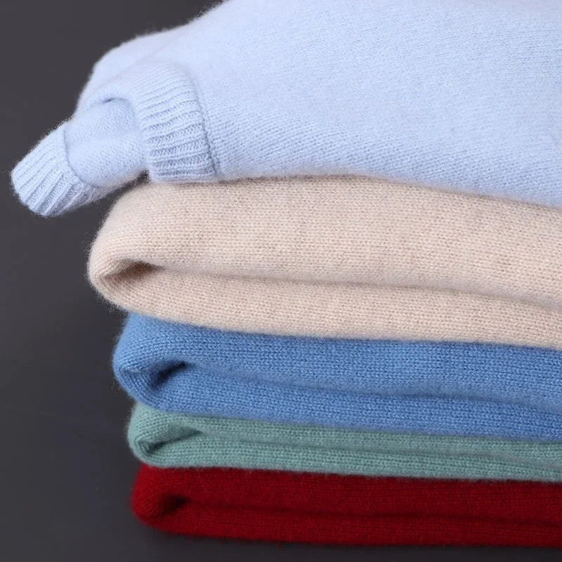 Folded stack of jumpers in blue, cream, red and green shades