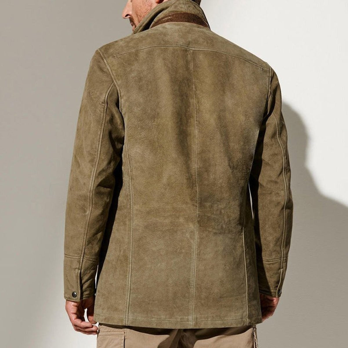 Rear view of olive suede jacket showing tailored back seams and stitching