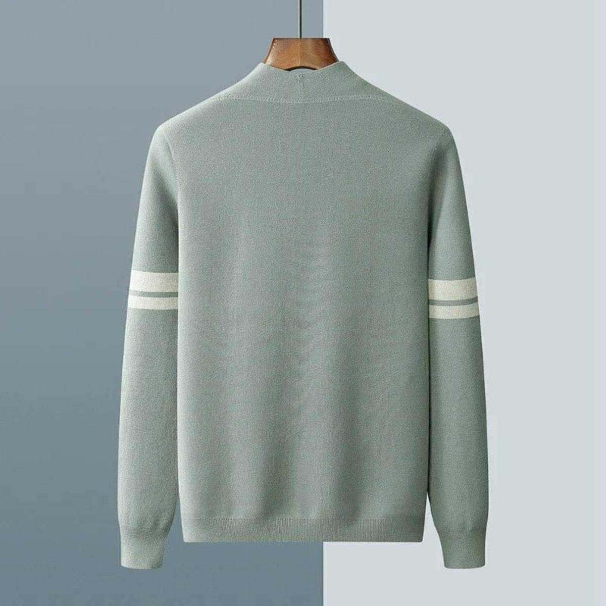 Rear view of sage green striped-sleeve cardigan hanging against grey background