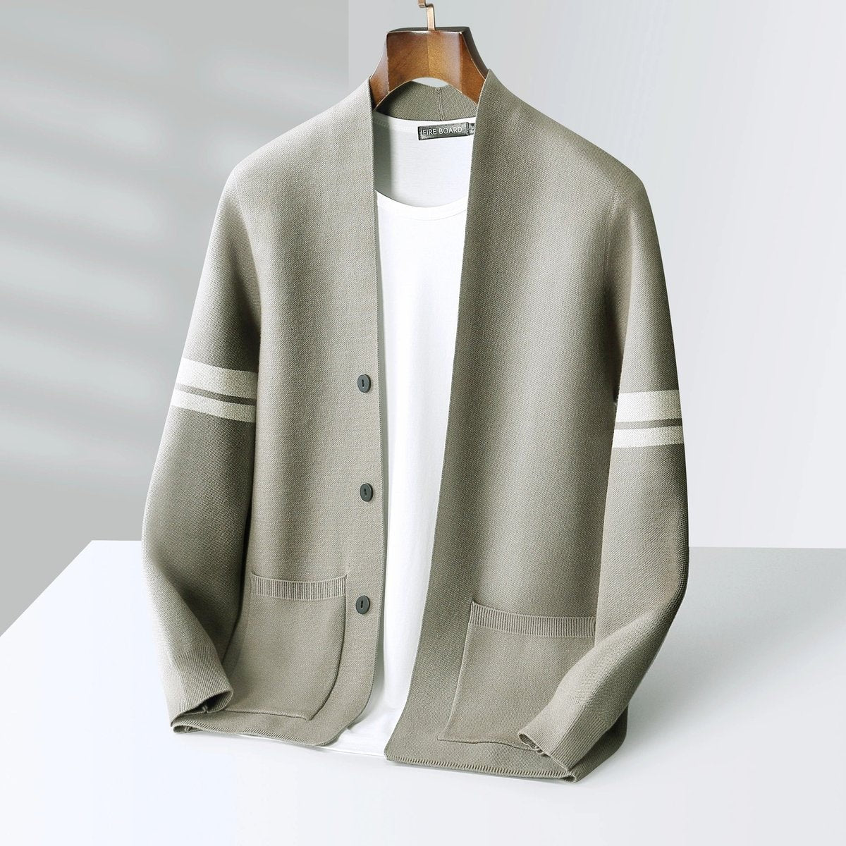 Khaki cardigan with cream striped sleeves and ribbed patch pockets