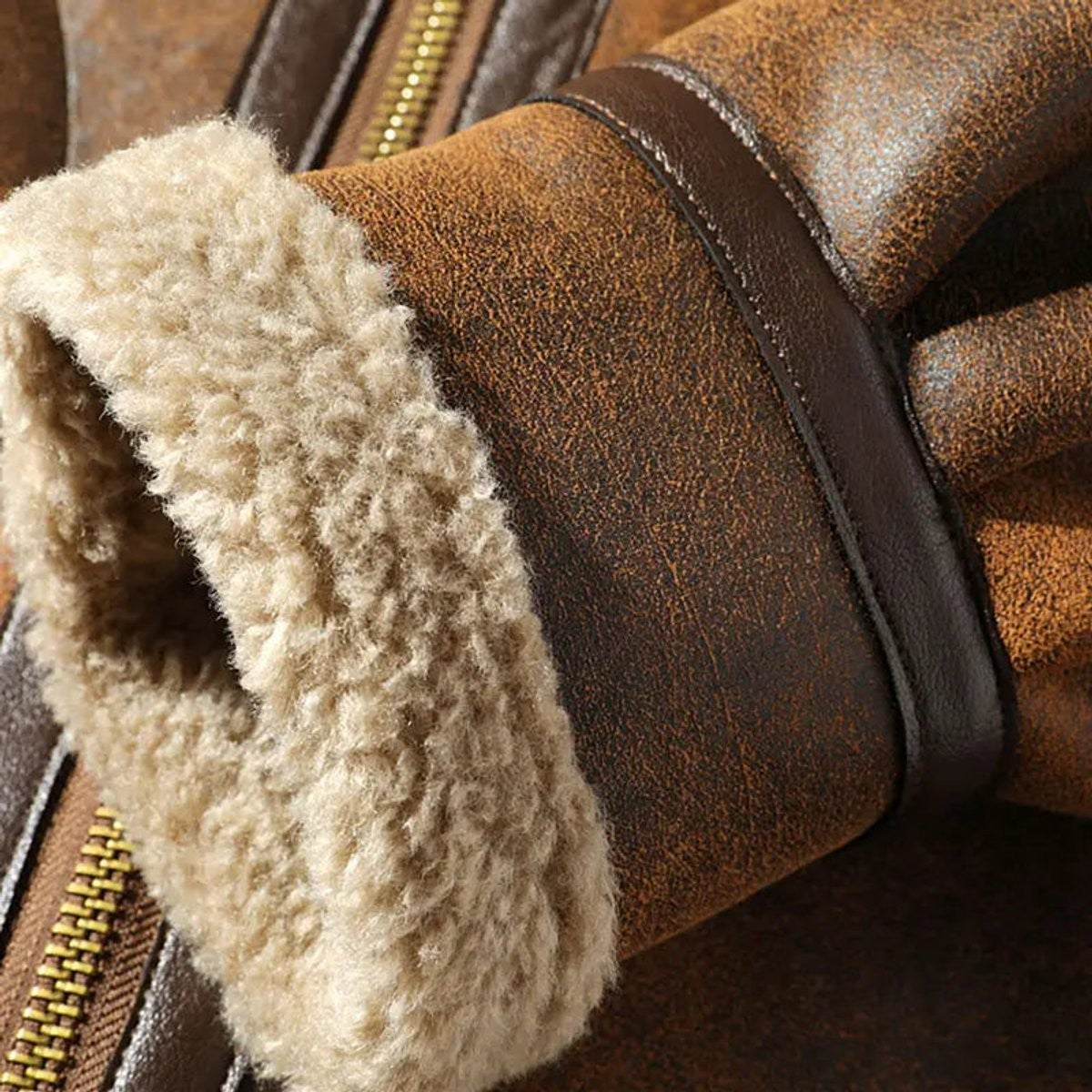 close-up of shearling cuff and suede sleeve on brown aviator bomber jacket