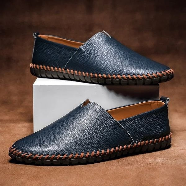 Navy pebbled-grain leather loafers with contrast whipstitch trim and slip-on design