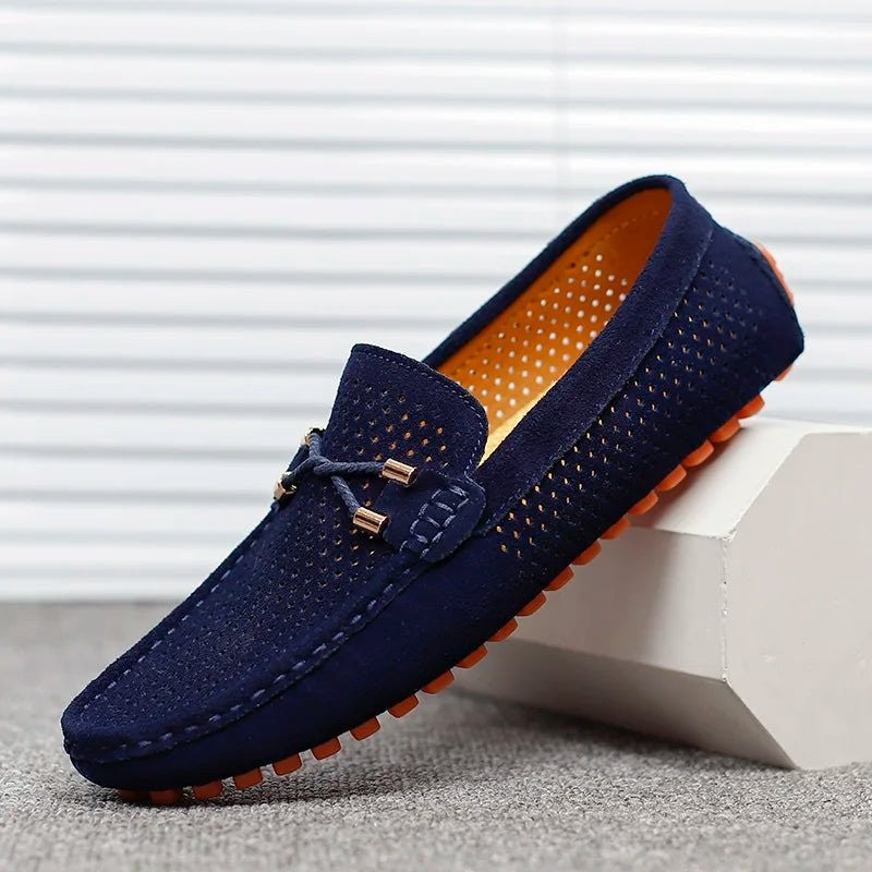 Navy suede driving loafers with perforated finish and orange rubber sole